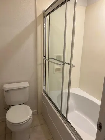 a bathroom with a toilet and a shower