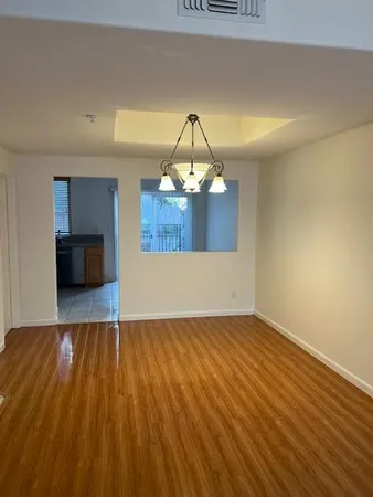 a view of empty room with wooden floor