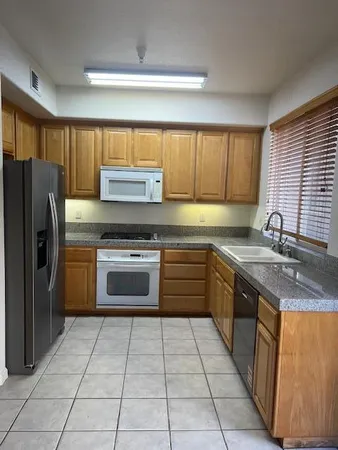 a kitchen with a stove a sink and a refrigerator