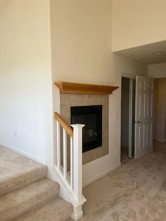 a view of an empty room and fire place