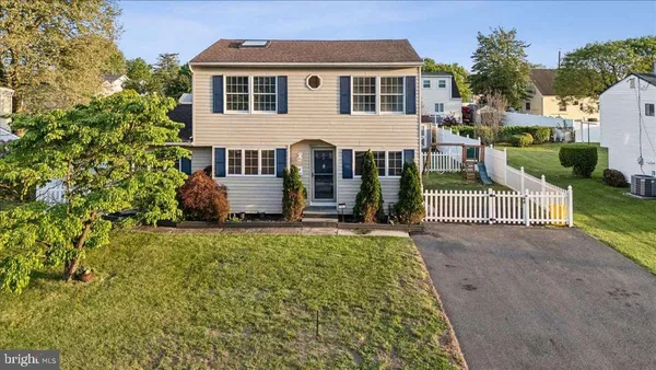 a view of a house with a yard and potted plants