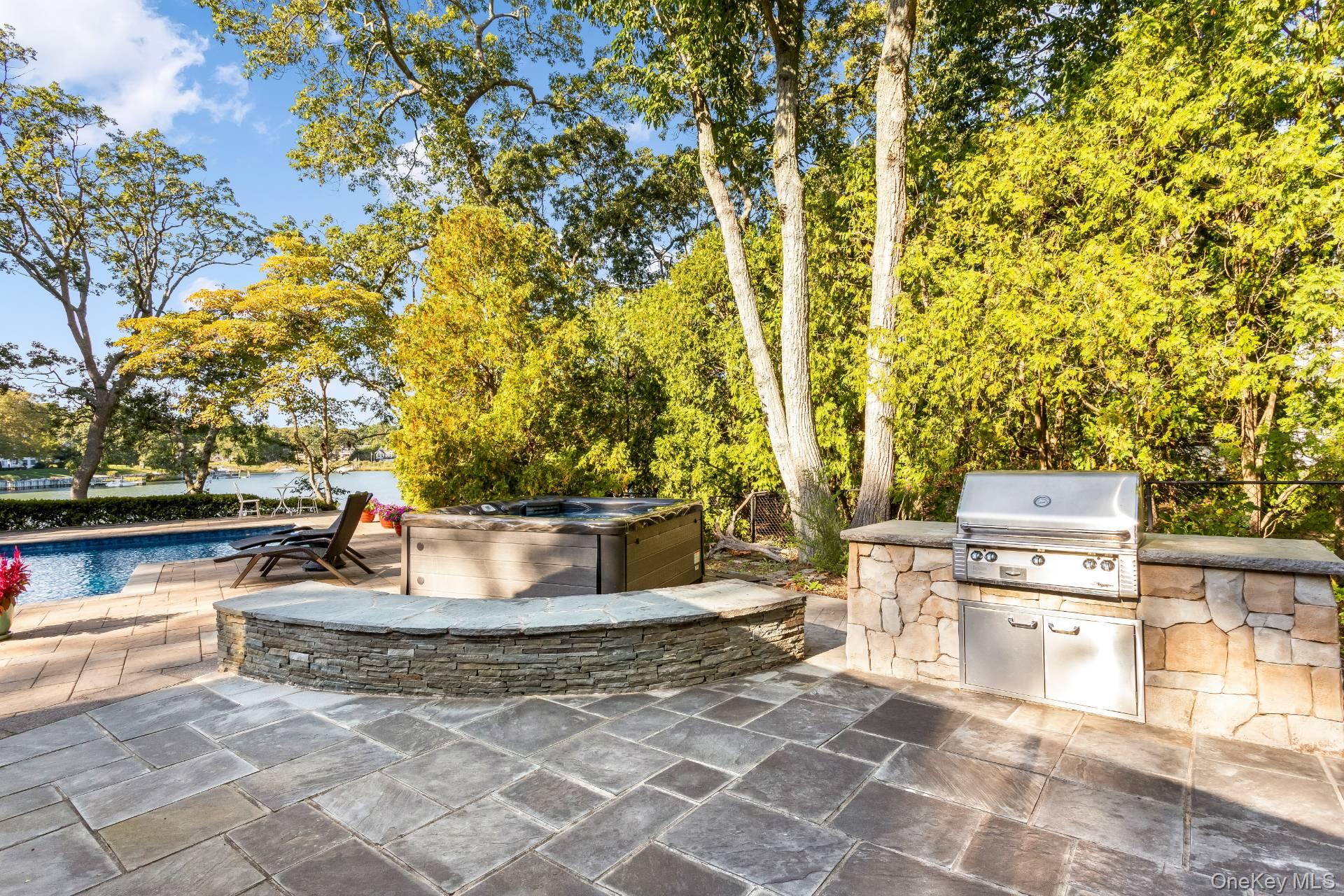 3693 Pine Neck Road Southold, NY 11971 - Photo 12 of 16 View of patio with a swimming pool, an outdoor kitchen, and a hot tub