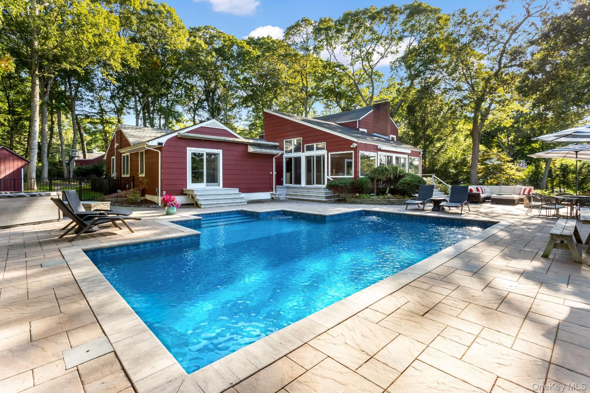 3693 Pine Neck Road Southold, NY 11971 - Photo 2 of 16 View of swimming pool featuring a patio area, entry steps, and outdoor lounge area