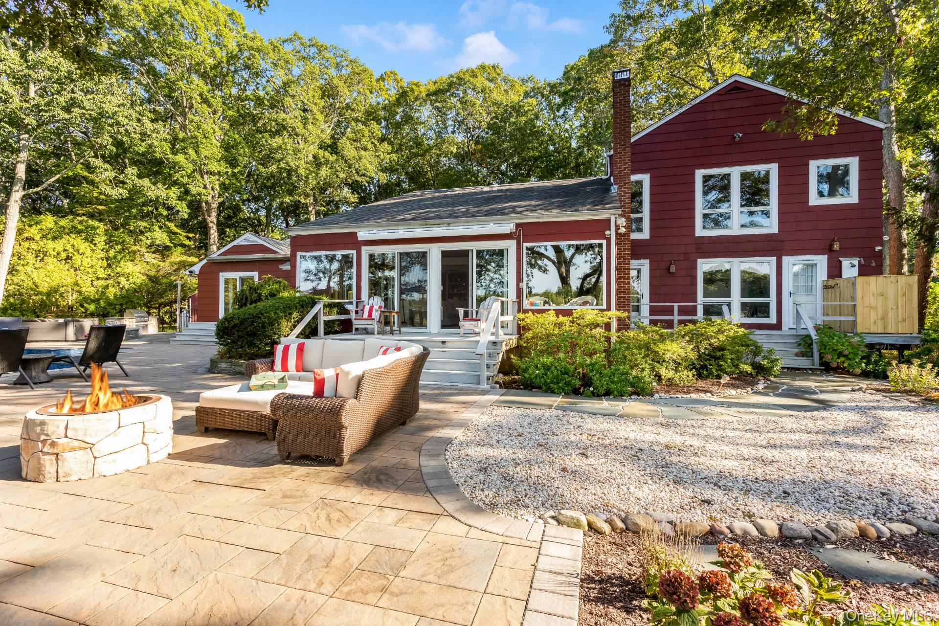 3693 Pine Neck Road Southold, NY 11971 - Photo 3 of 16 Back of property featuring a chimney, an outdoor living space with a fire pit, and a patio