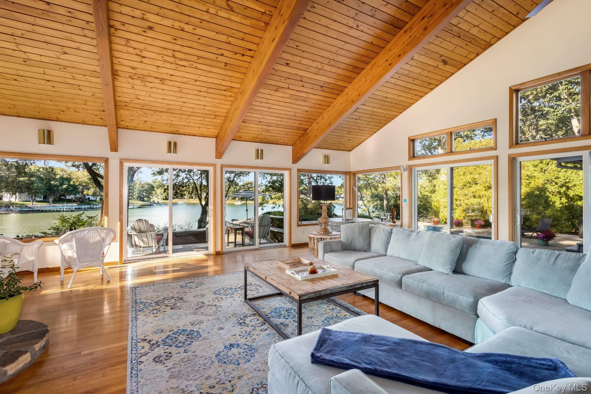 3693 Pine Neck Road Southold, NY 11971 - Photo 6 of 16 Living room featuring high vaulted ceiling, a wooden ceiling with exposed beams, and wood finished floors