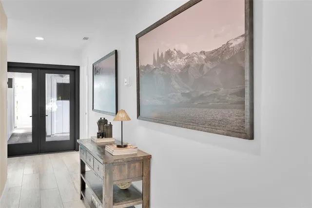 a view of a table and chairs under an umbrella in backyard