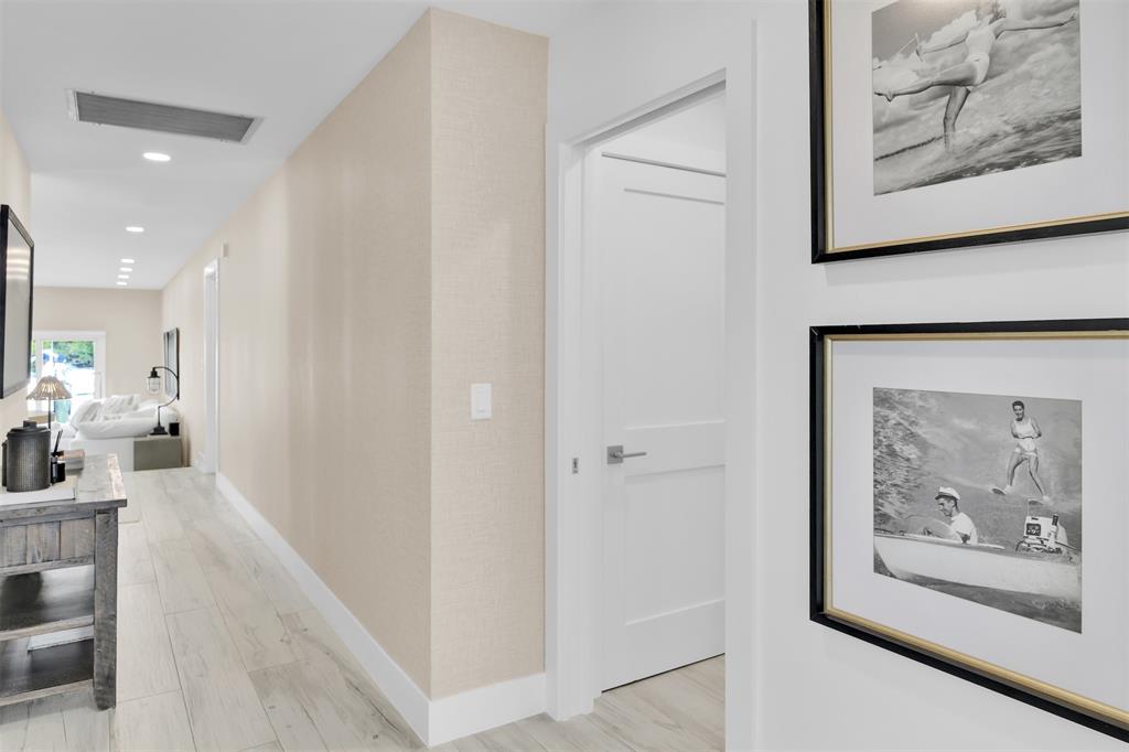 17026 Bay Street Jupiter, FL 33477 - Photo 22 of 77 a view of a hallway with wooden floor and dining area