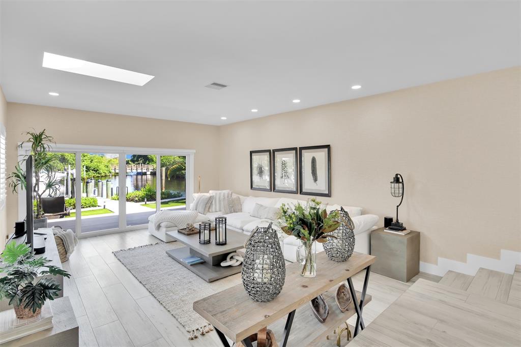 17026 Bay Street Jupiter, FL 33477 - Photo 25 of 77 a living room with furniture and a potted plant