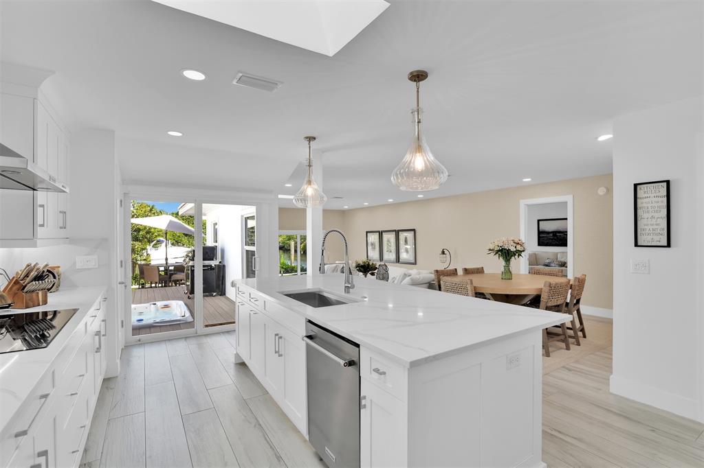 17026 Bay Street Jupiter, FL 33477 - Photo 29 of 77 a large kitchen with sink a counter top space and living room view