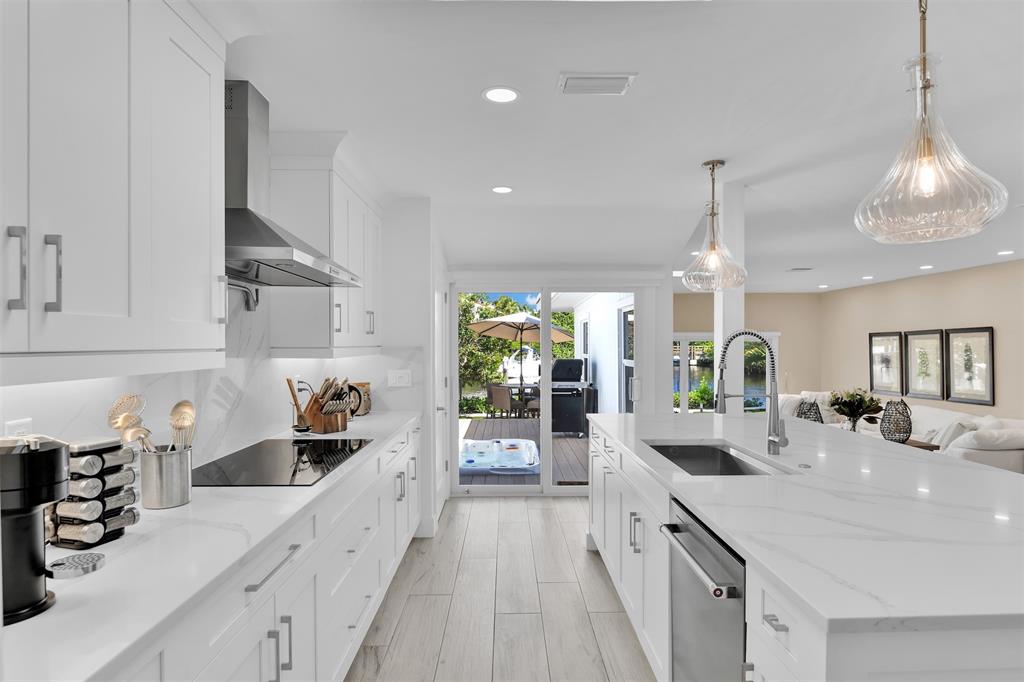 17026 Bay Street Jupiter, FL 33477 - Photo 30 of 77 a kitchen with stainless steel appliances a sink stove and cabinets
