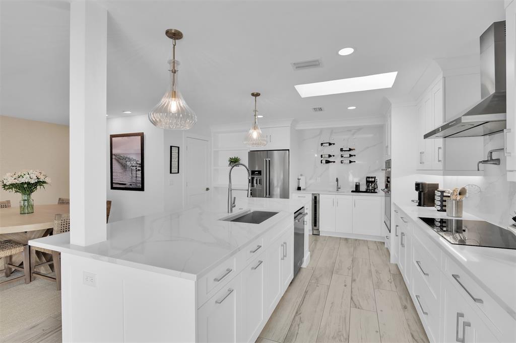 17026 Bay Street Jupiter, FL 33477 - Photo 36 of 77 a large white kitchen with a lot of counter space