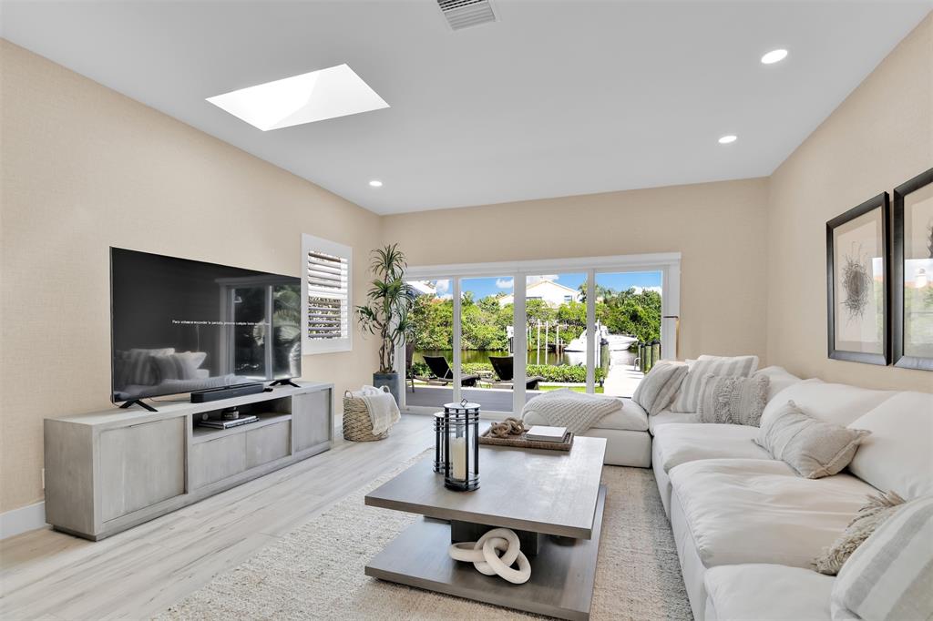 17026 Bay Street Jupiter, FL 33477 - Photo 37 of 77 a living room with furniture and a flat screen tv