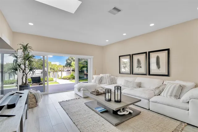 a living room with fireplace furniture and a flat screen tv