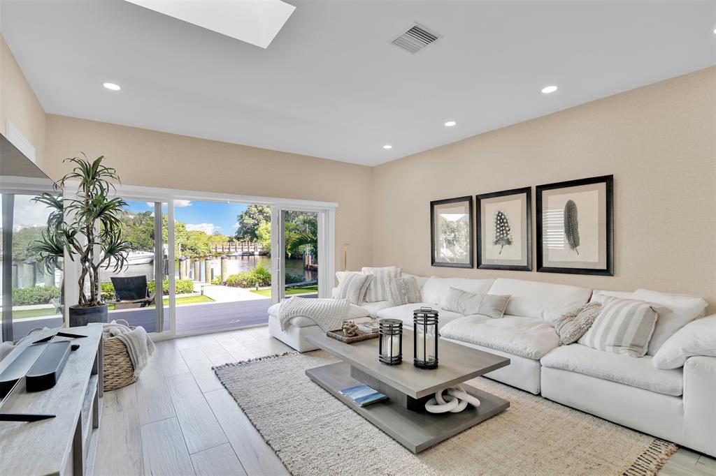 17026 Bay Street Jupiter, FL 33477 - Photo 38 of 77 a living room with furniture and a large window