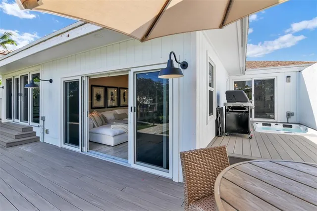 a view of a porch with wooden floor and fence