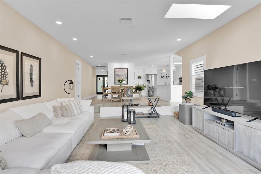 17026 Bay Street Jupiter, FL 33477 - Photo 54 of 77 a living room with furniture a rug and kitchen view