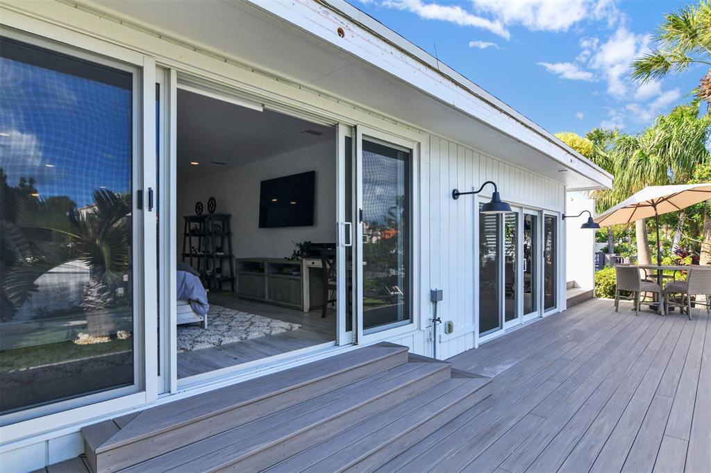 17026 Bay Street Jupiter, FL 33477 - Photo 59 of 77 a view of a porch with wooden floor and fence