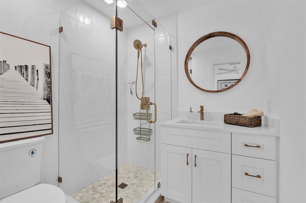 17026 Bay Street Jupiter, FL 33477 - Photo 70 of 77 a bathroom with a sink a mirror and a shower