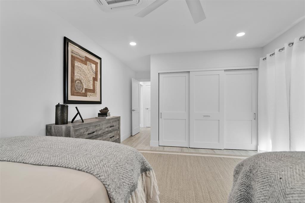 17026 Bay Street Jupiter, FL 33477 - Photo 73 of 77 a bedroom with a bed and cabinet