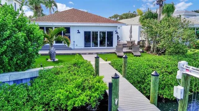 an aerial view of house with yard and lake view
