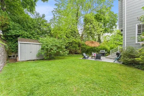 a view of a backyard with plants and a patio