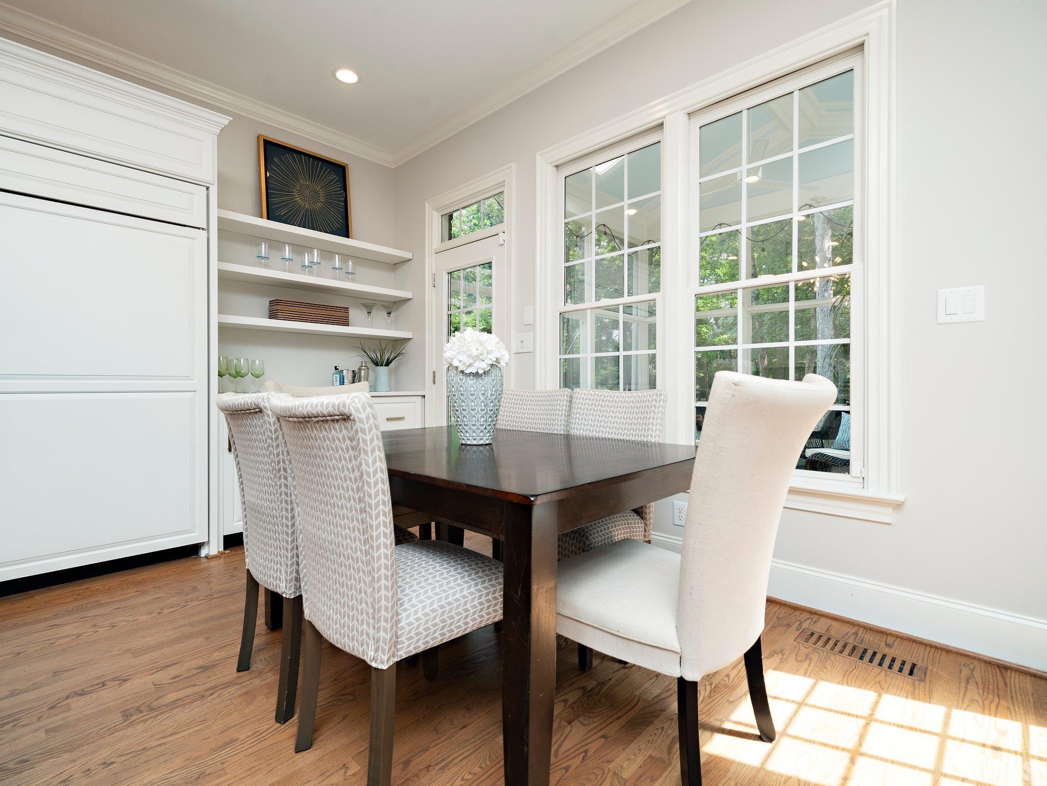 8104 Harps Mill Road Raleigh, NC 27615 - Photo 21 of 57 a view of a dining room with furniture window and wooden floor