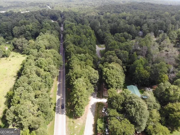 an aerial view of a houses with yard