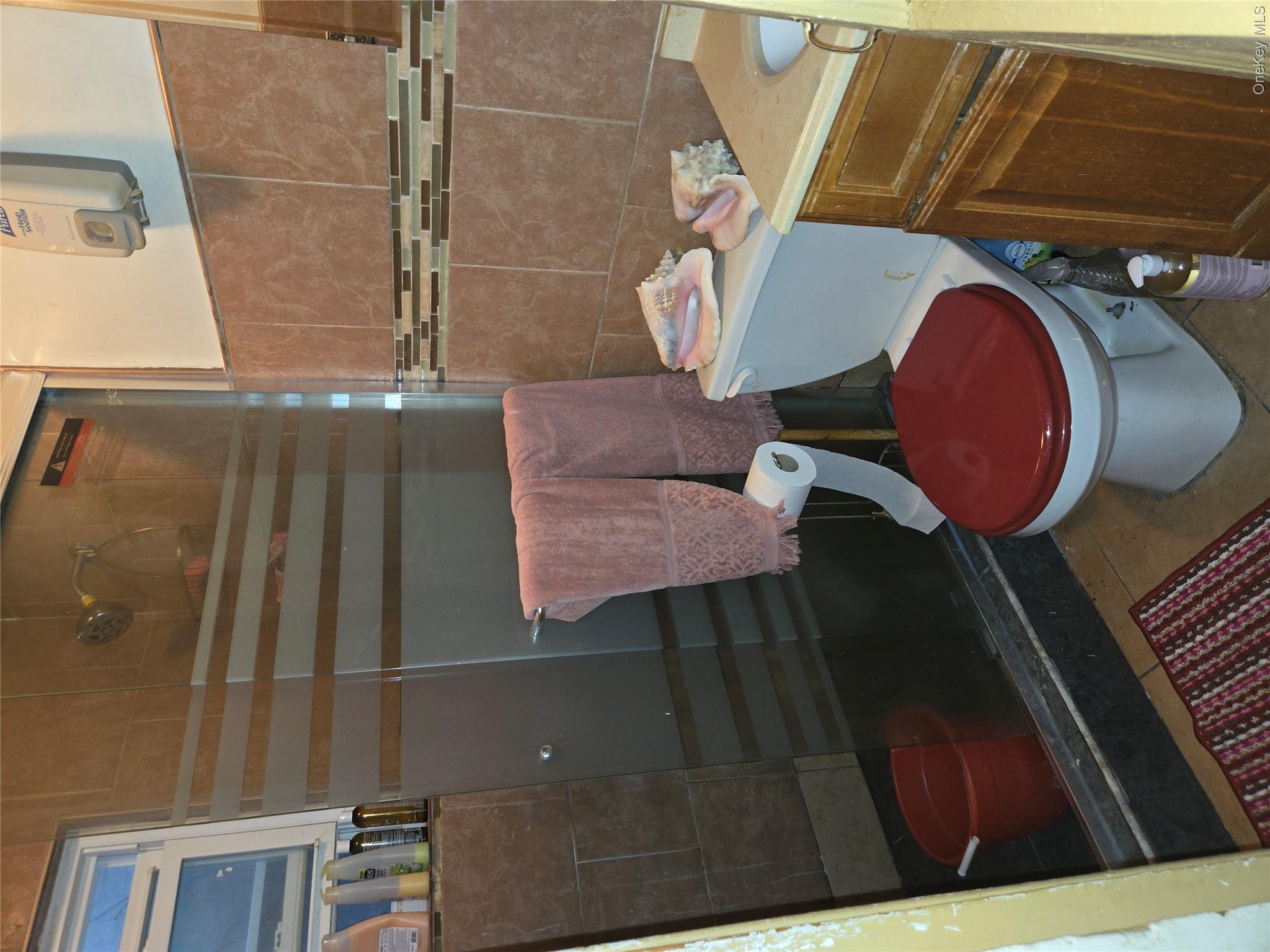 343 Rutland Road Brooklyn, NY 11225 - Photo 2 of 17 Bathroom with a stall shower, vanity, tile patterned floors, and tile walls