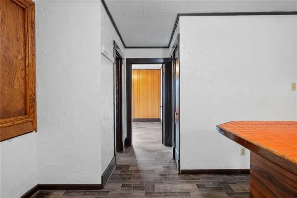 a view of a room with wooden floor