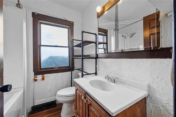 a bathroom with a sink a toilet and mirror