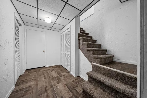 a view of entryway and hall with wooden floor