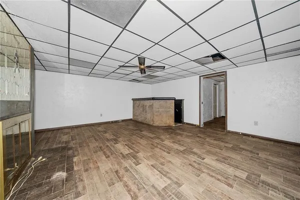 a view of a livingroom with a ceiling fan and window