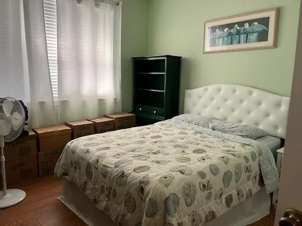a bedroom with a bed and window
