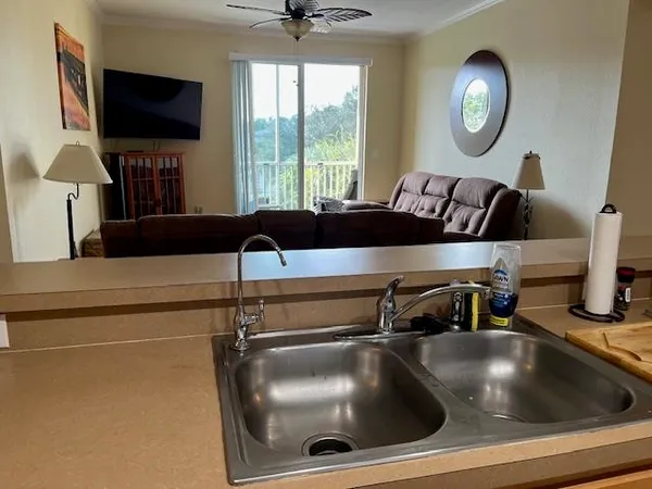 a kitchen with a sink and a mirror