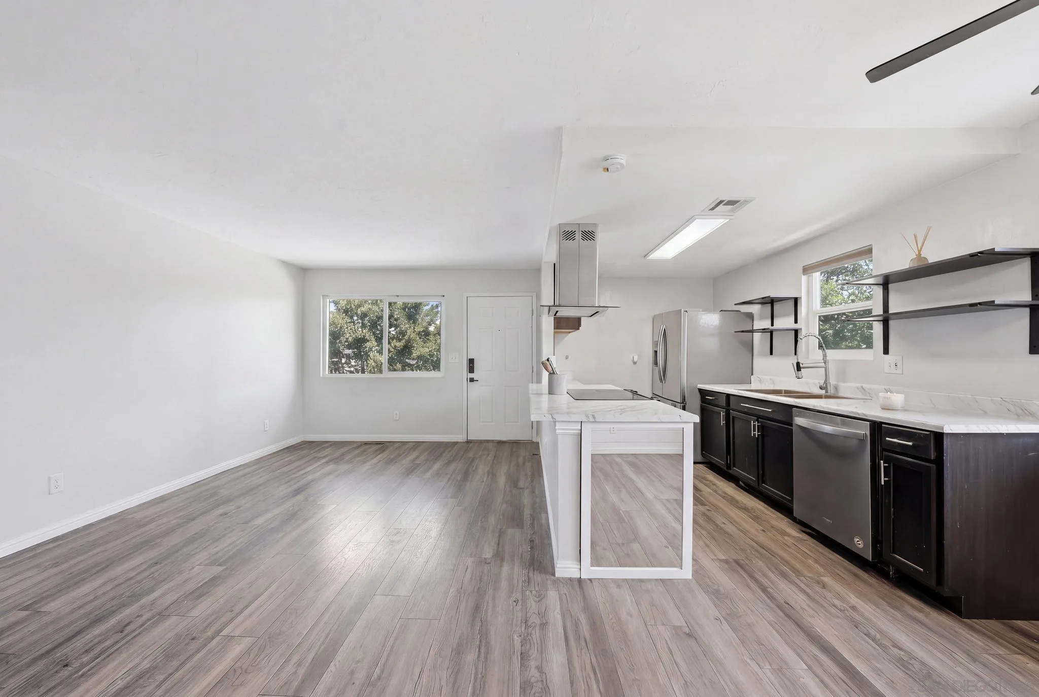 9926 Mission Vega Road, Unit 4 Santee, CA 92071 - Photo 6 of 30 a kitchen with stainless steel appliances granite countertop a stove a sink dishwasher and a refrigerator with wooden floor