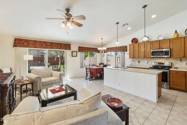 a living room with furniture and kitchen view
