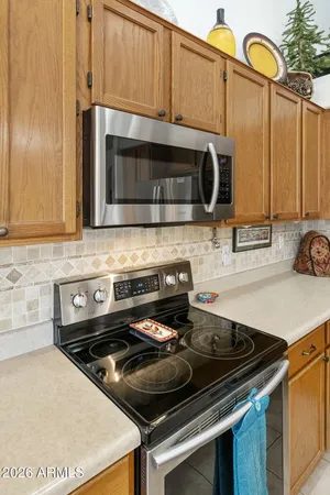 a kitchen with granite countertop a stove and a microwave