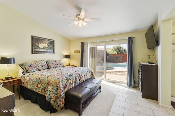 a bedroom with a large bed and a chandelier