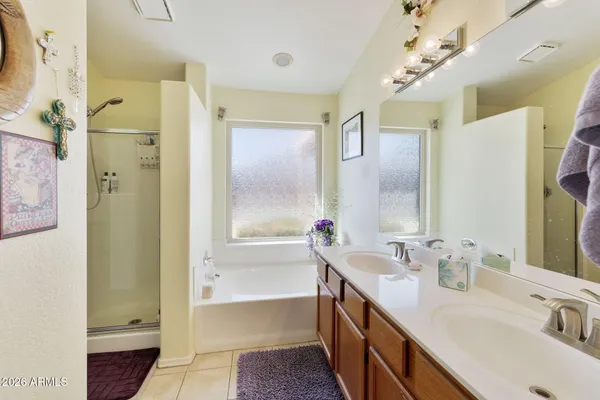 a bathroom with a tub sink shower and a mirror