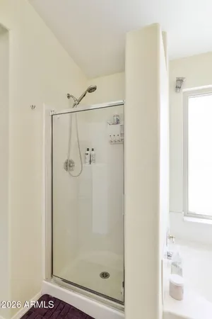 a bathroom with a glass shower door