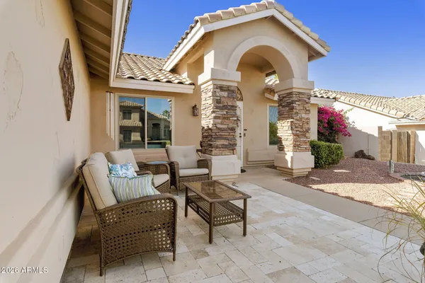 a front view of a house with outdoor seating