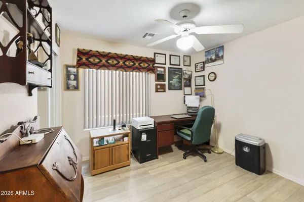 a view of a workspace with furniture and a window