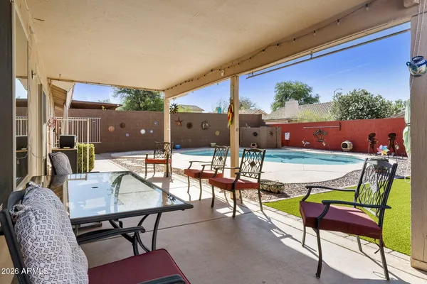 a view of a patio with a table and chairs