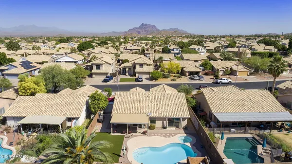 an aerial view of residential houses with outdoor space and swimming pool