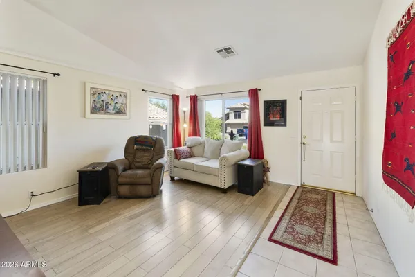 a living room with furniture and a rug