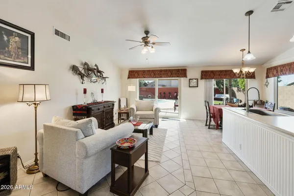 a living room with furniture and a chandelier