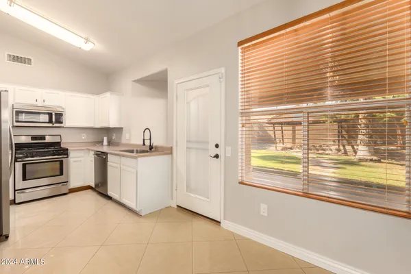 a kitchen with granite countertop a refrigerator and a stove