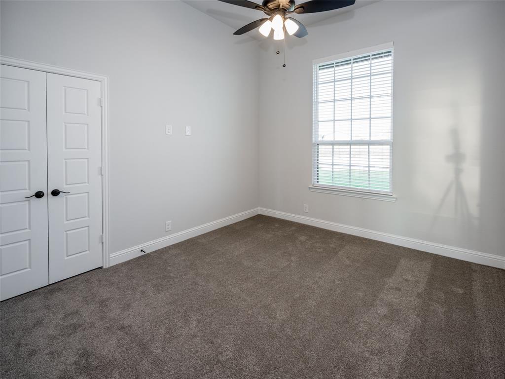 2108 Charters Circle Nevada, TX 75173 - Photo 22 of 37 Spare room with dark carpet and a ceiling fan