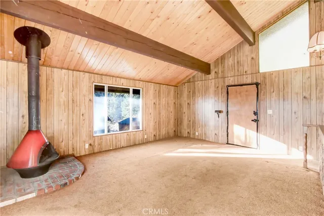 a large white kitchen with granite countertop a lot of counter space and glass door