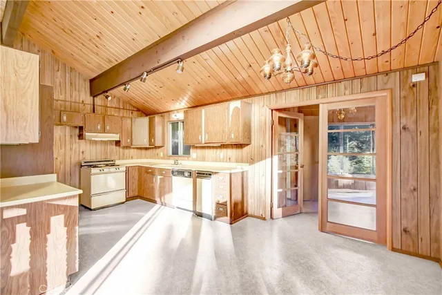 a large white kitchen with a large window